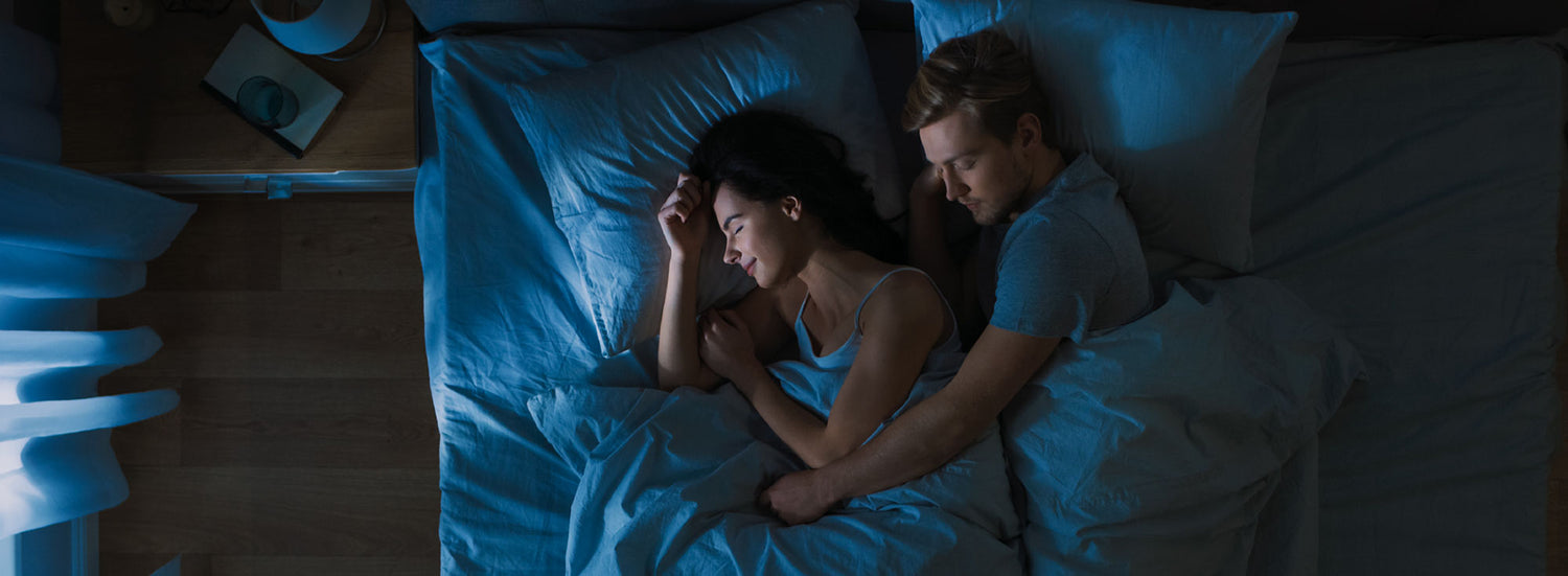 Couple sleeping peacefully — premium bedding at Mikey Mattress